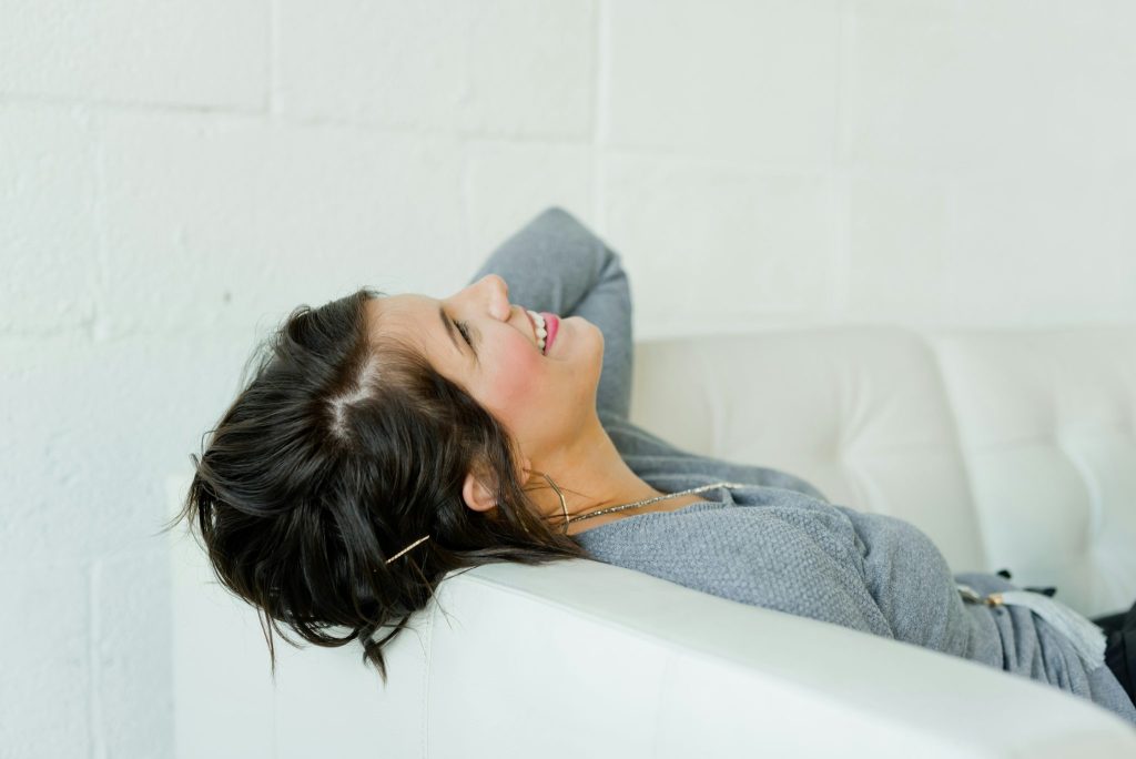 Acceptance and commitment therapy. Woman smiling on couch